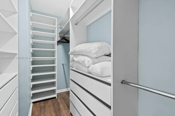 a view of walk in closet with empty racks