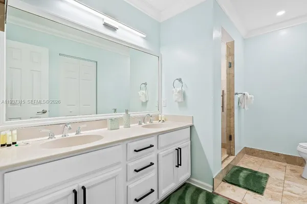a bathroom with a sink double vanity and a mirror