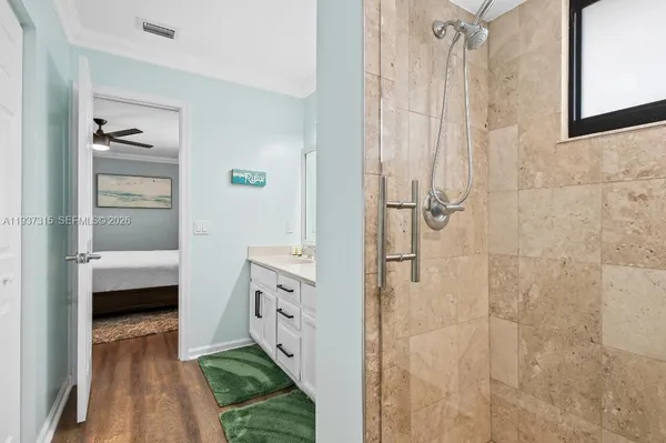 a en suite bathroom with a shower and a sink