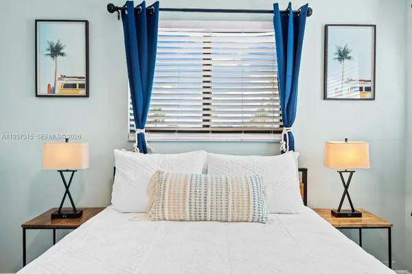 a bedroom with a bed and a lamp