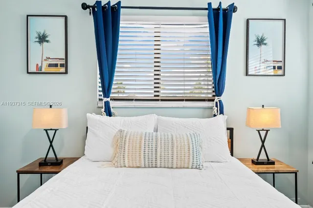 a bedroom with a bed and a lamp