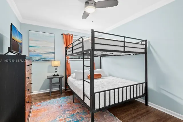 a bedroom with a bunk bed and a window