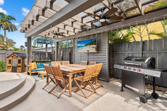 a view of a patio with a table and chairs and couches