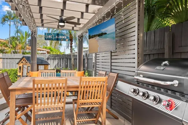 a view of a patio with table and chairs and potted plants