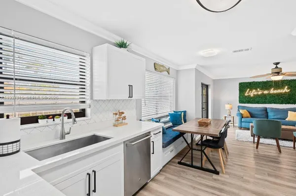 a kitchen with a sink cabinets and wooden floor
