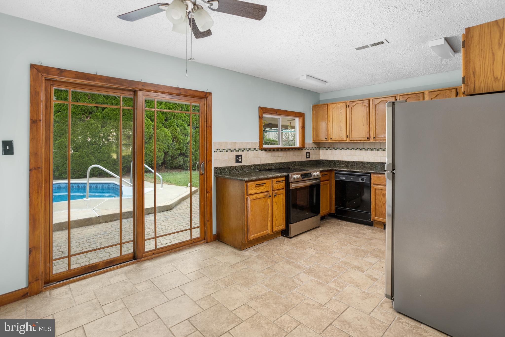 23 Cotton Road Levittown, PA 19057 - Photo 9 of 36 a view of a kitchen with a sink and cabinets