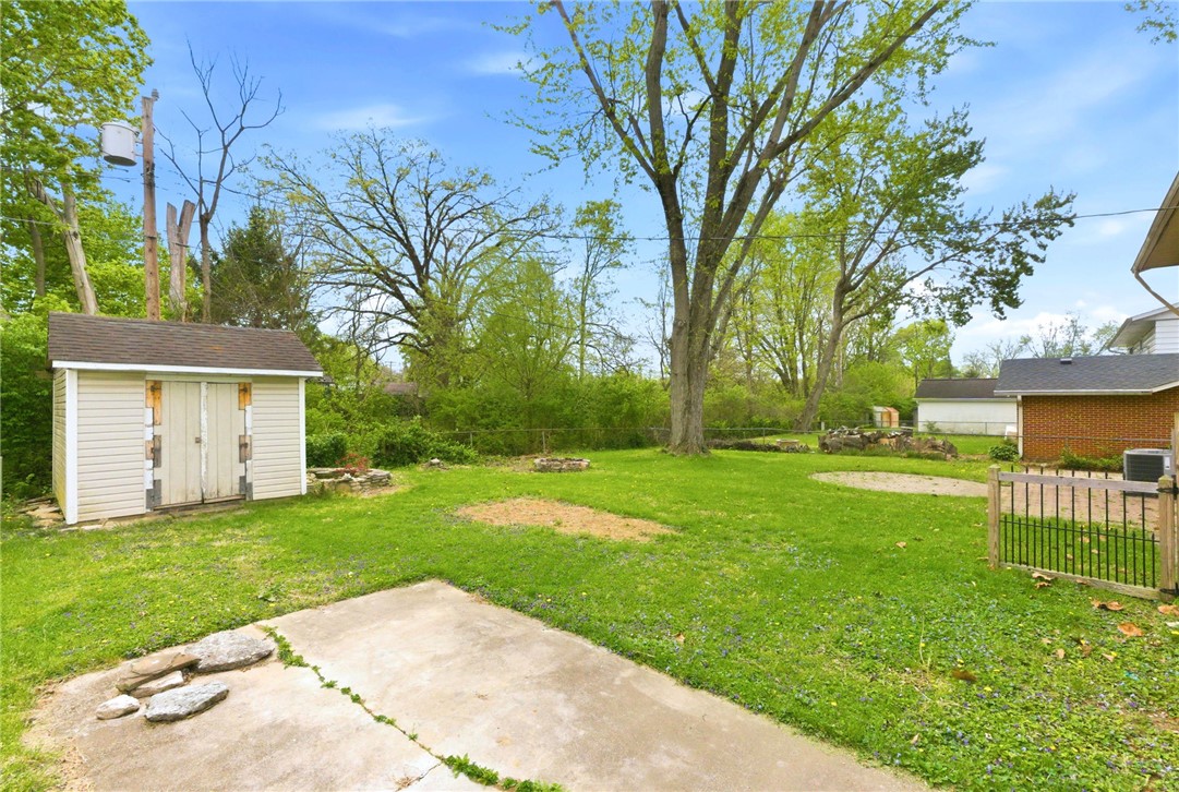 40 Woods Road Springboro, OH 45066 - Photo 8 of 57 This spacious backyard offers a perfect blend of open green space and functional features for outdoor enjoyment.