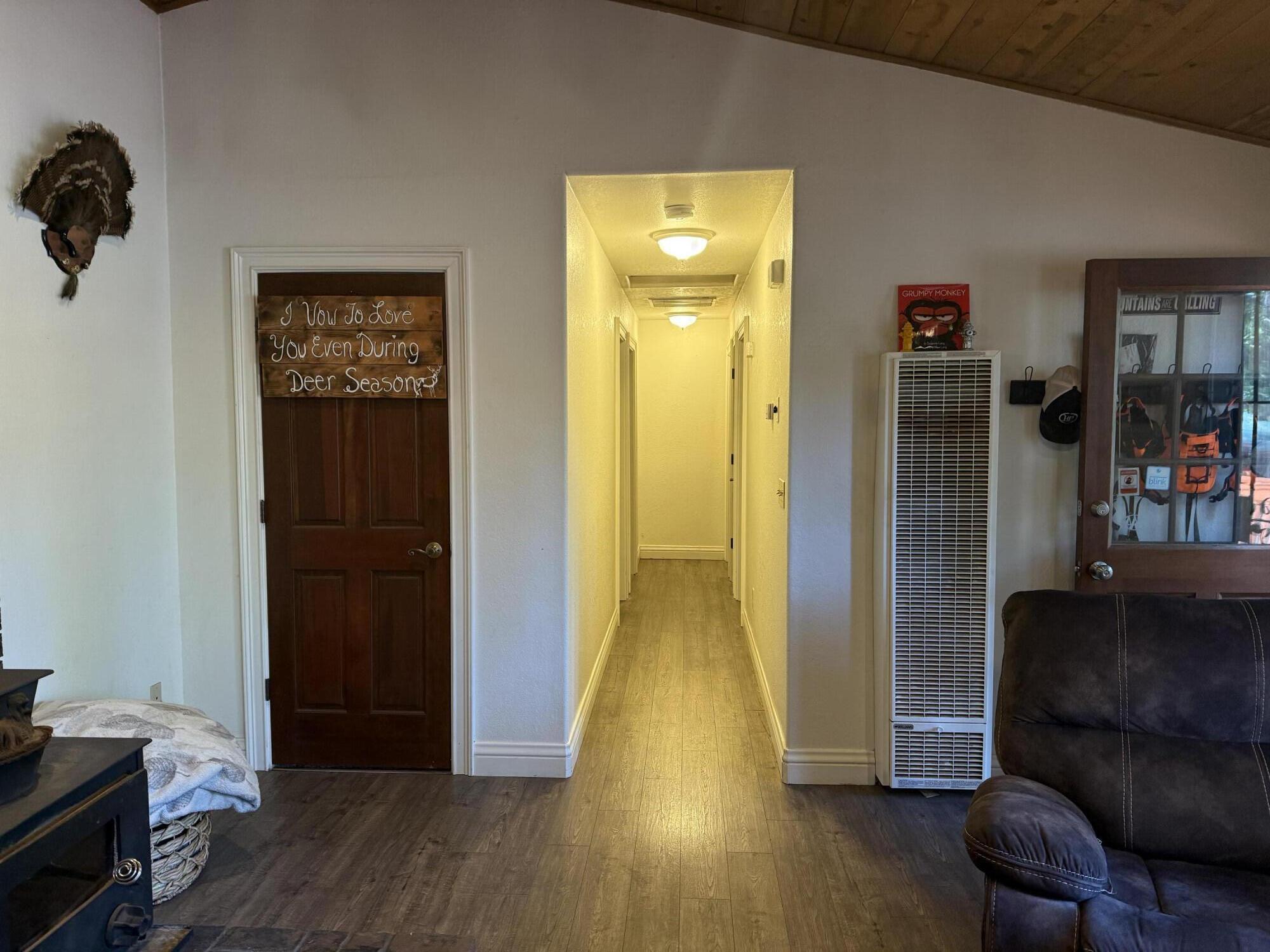 7097 Shasta Forest Drive Shingletown, CA 96088 - Photo 13 of 44 a view of a hallway with wooden floor and closet