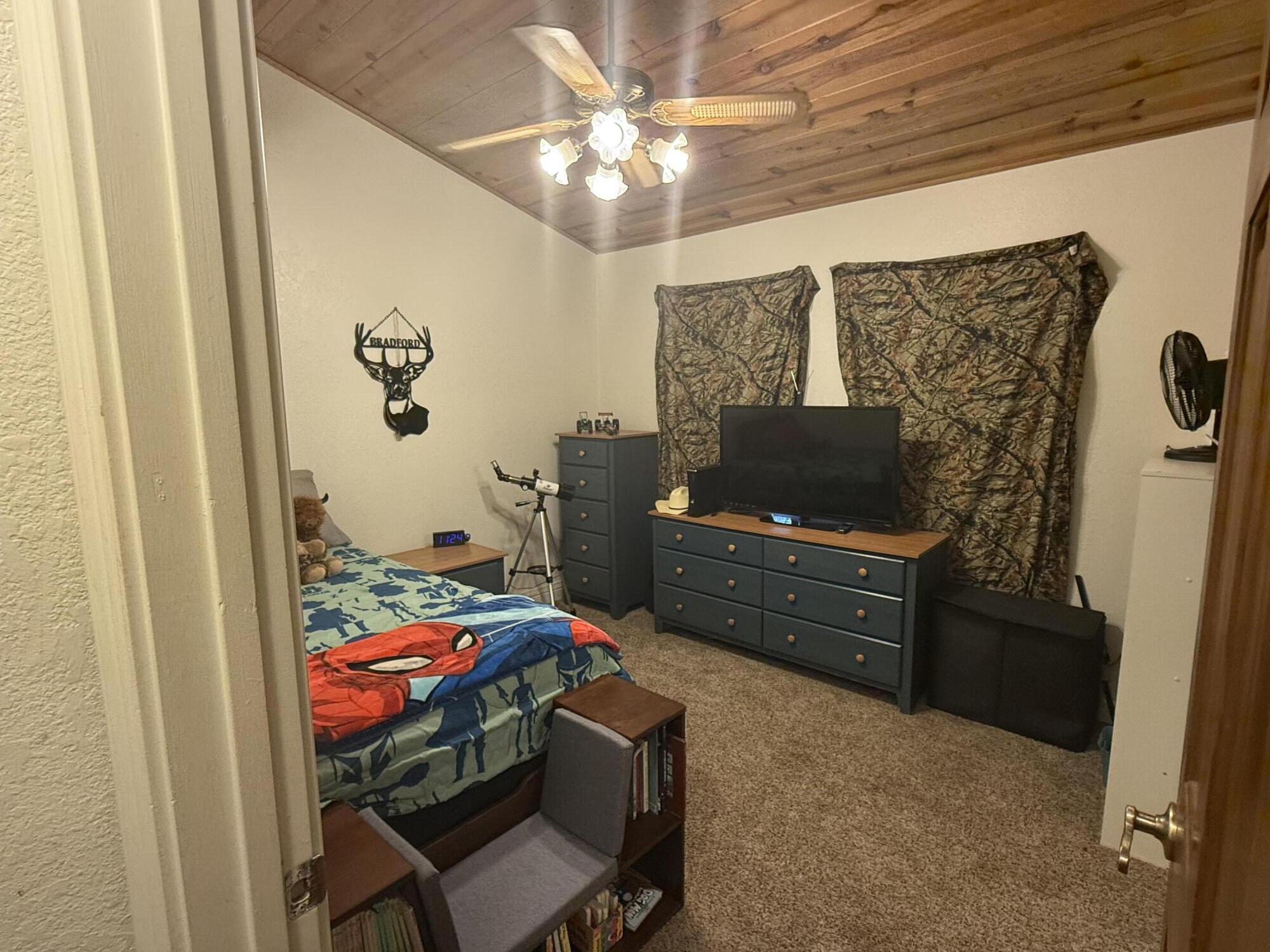 7097 Shasta Forest Drive Shingletown, CA 96088 - Photo 17 of 44 a bedroom with a bed and furniture