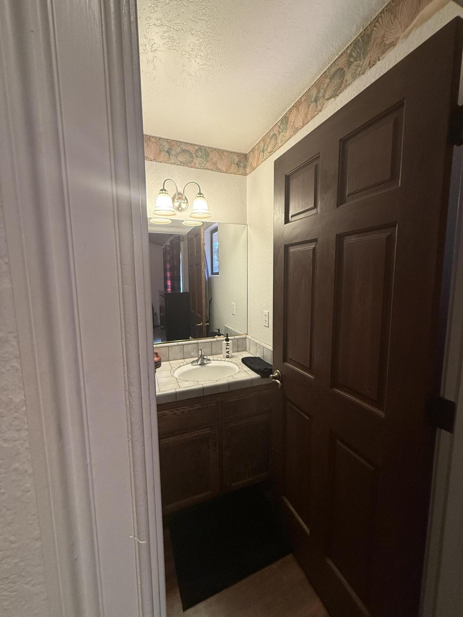7097 Shasta Forest Drive Shingletown, CA 96088 - Photo 22 of 44 a view of bathroom with mirror and window