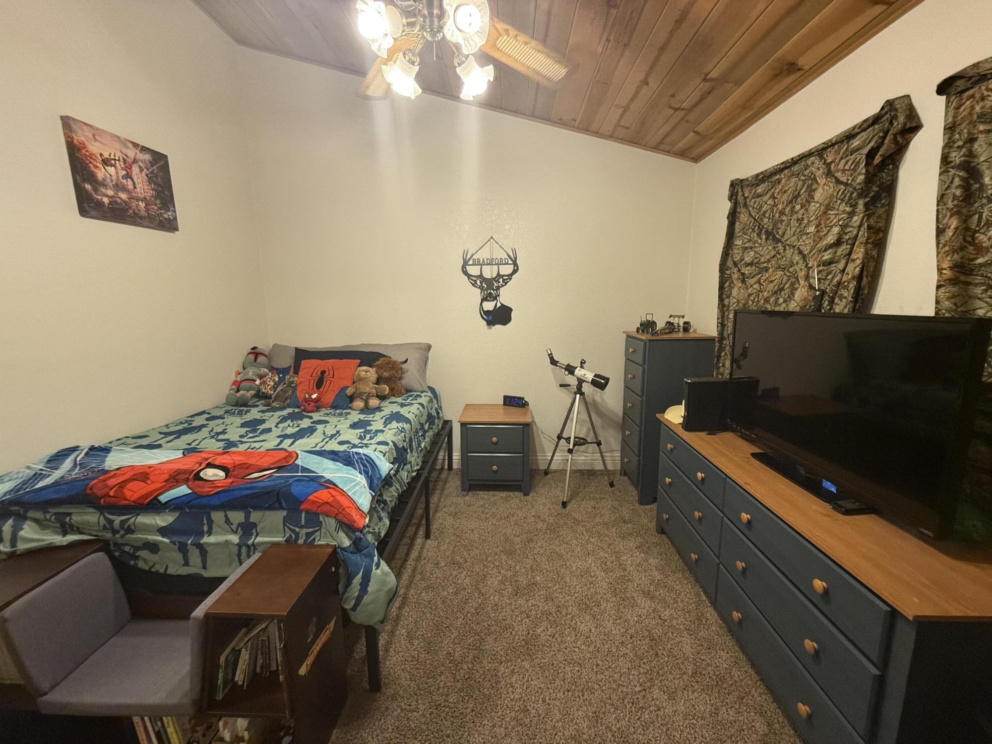 7097 Shasta Forest Drive Shingletown, CA 96088 - Photo 42 of 44 a bedroom with furniture and a flat screen tv