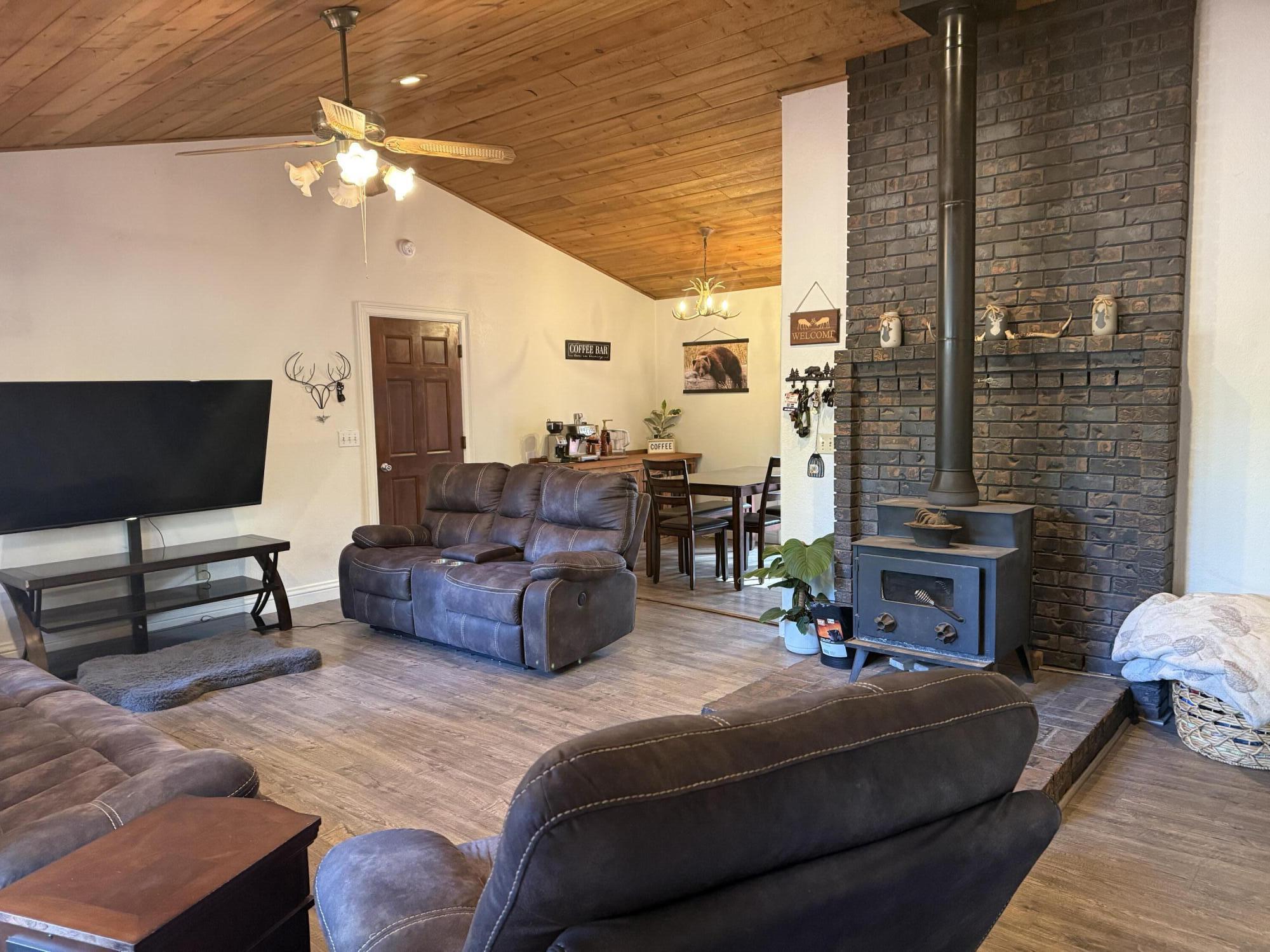 7097 Shasta Forest Drive Shingletown, CA 96088 - Photo 5 of 44 a living room with furniture and a flat screen tv