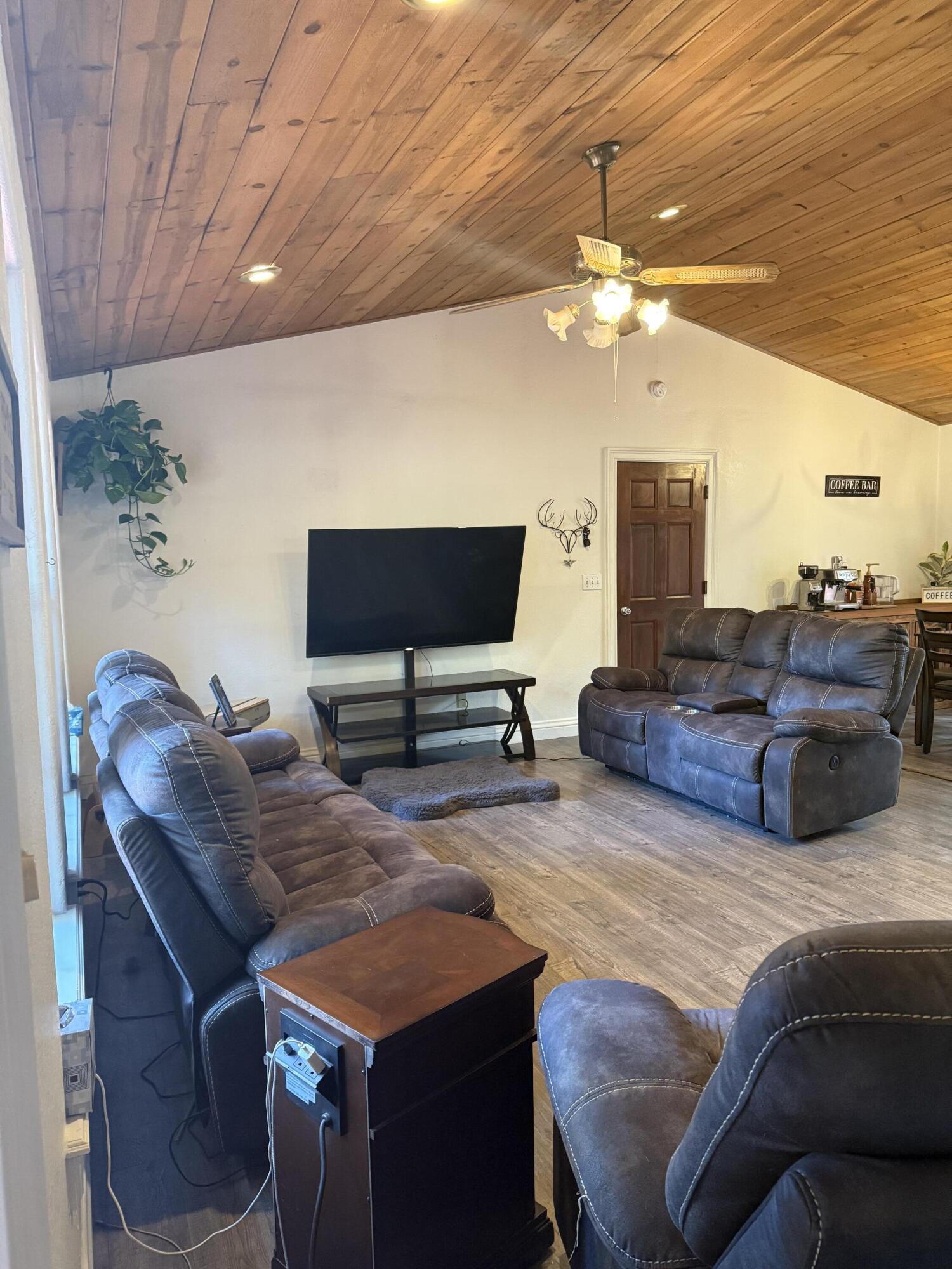 7097 Shasta Forest Drive Shingletown, CA 96088 - Photo 6 of 44 a living room with furniture and a flat screen tv