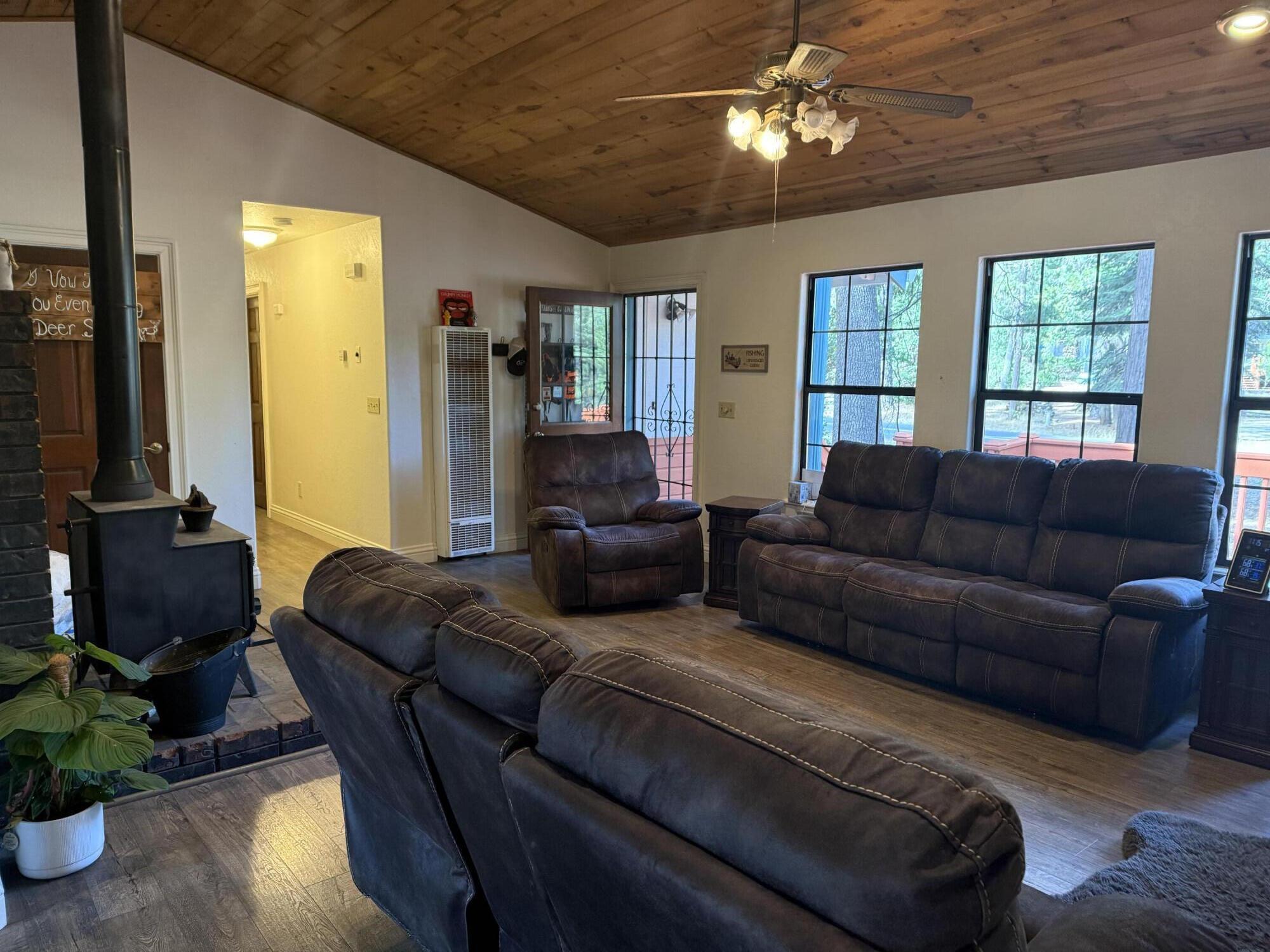7097 Shasta Forest Drive Shingletown, CA 96088 - Photo 7 of 44 a living room with furniture a ceiling fan and a window