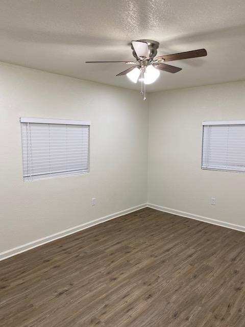 15792 Raymond Road Madera, CA 93638 - Photo 8 of 18 a view of an empty room with wooden floor and a ceiling fan