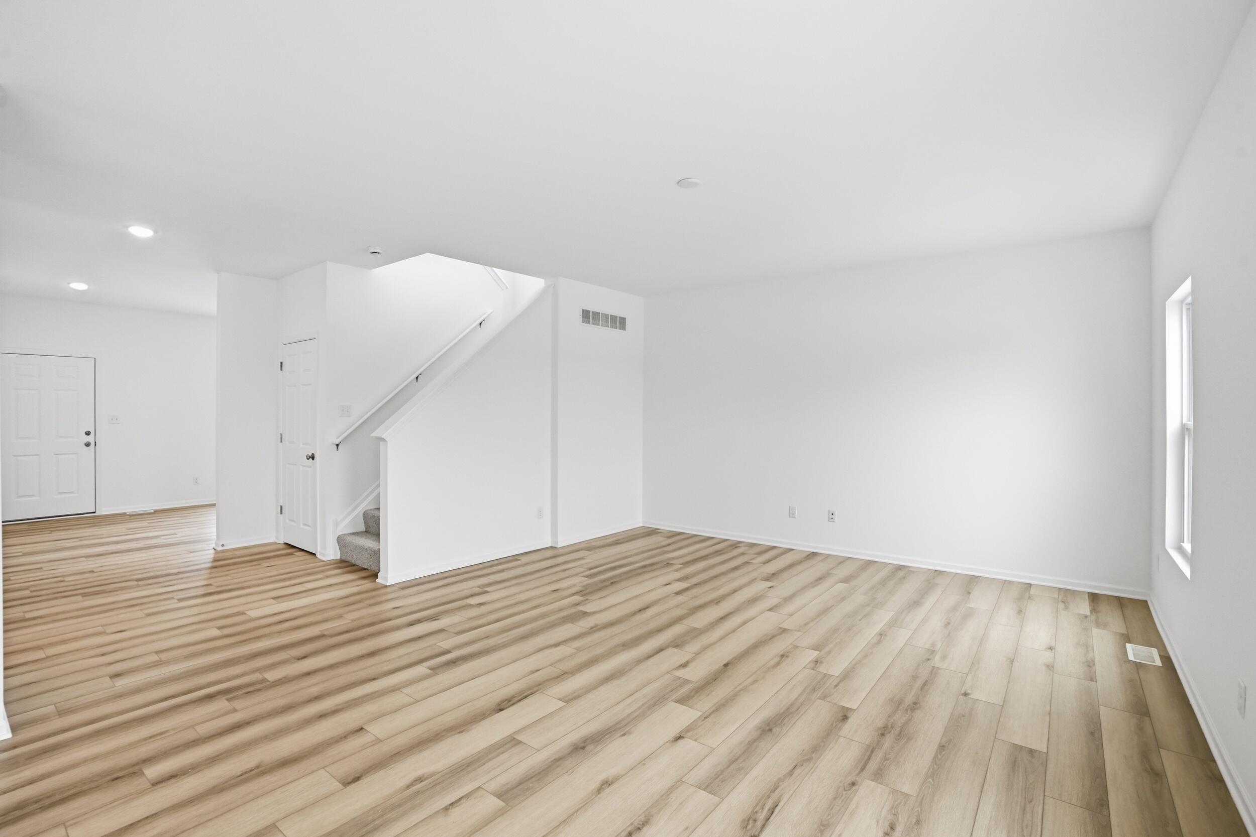 6587 East 104th Avenue Winfield, IN 46307 - Photo 13 of 34 an empty room with wooden floor and entryway