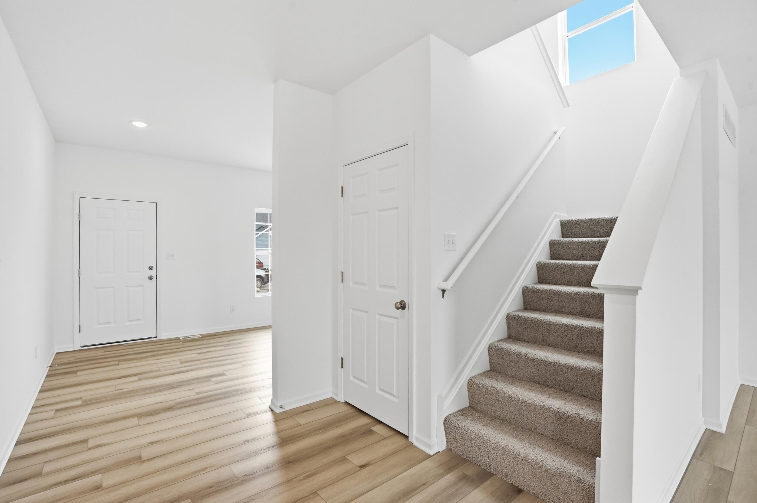 6587 East 104th Avenue Winfield, IN 46307 - Photo 15 of 34 a view of an entryway with wooden floor