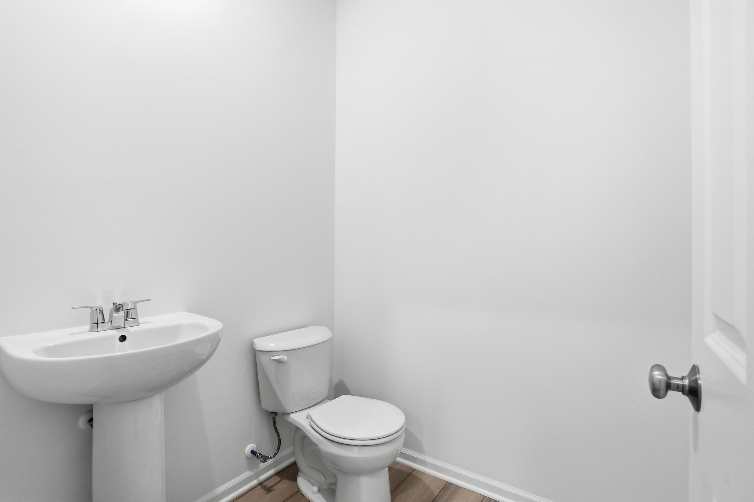 6587 East 104th Avenue Winfield, IN 46307 - Photo 16 of 34 a bathroom with a sink and a toilet