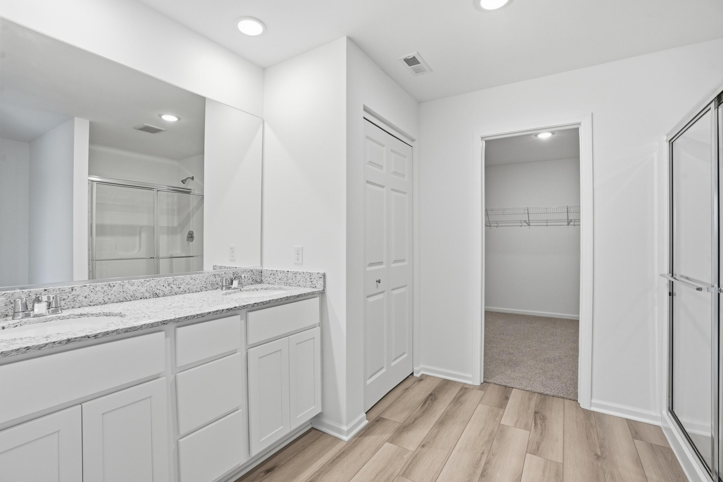 6587 East 104th Avenue Winfield, IN 46307 - Photo 20 of 34 a bathroom with a double vanity sink and mirror
