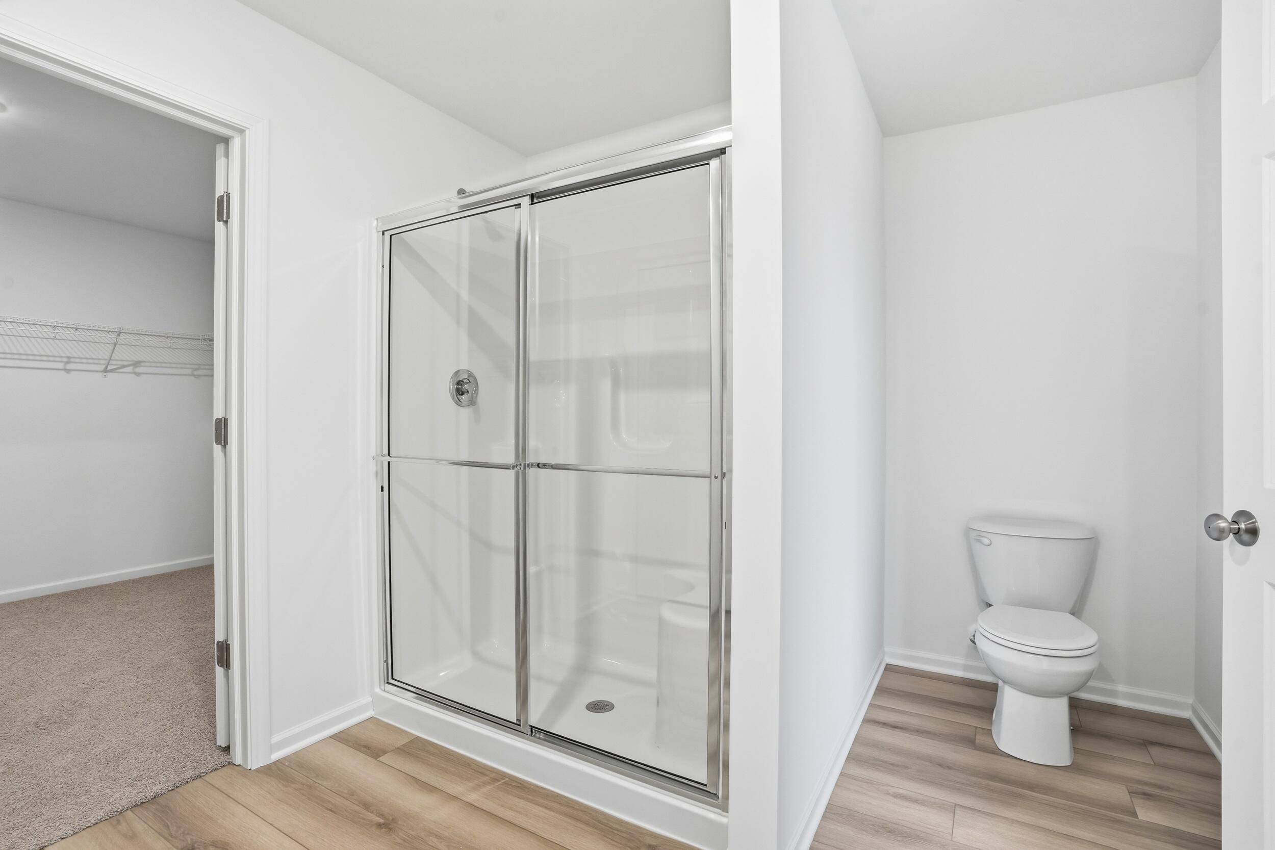 6587 East 104th Avenue Winfield, IN 46307 - Photo 22 of 34 a bathroom with a toilet and a shower