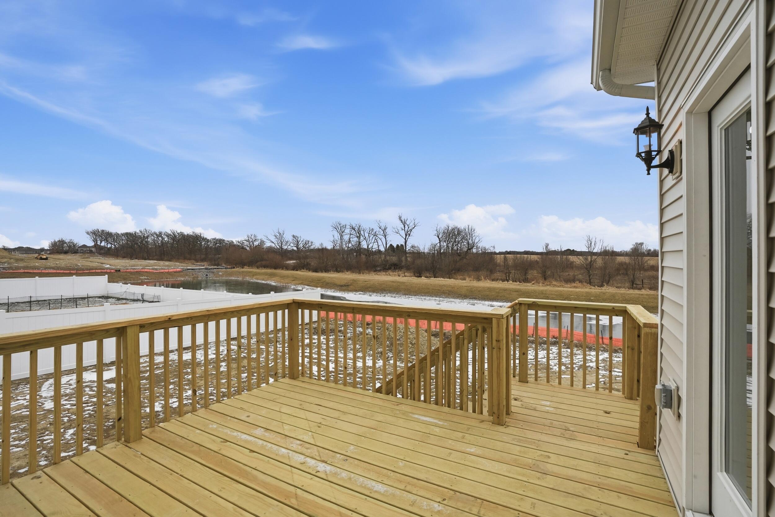 6587 East 104th Avenue Winfield, IN 46307 - Photo 33 of 34 a view of balcony with wooden floor & fence