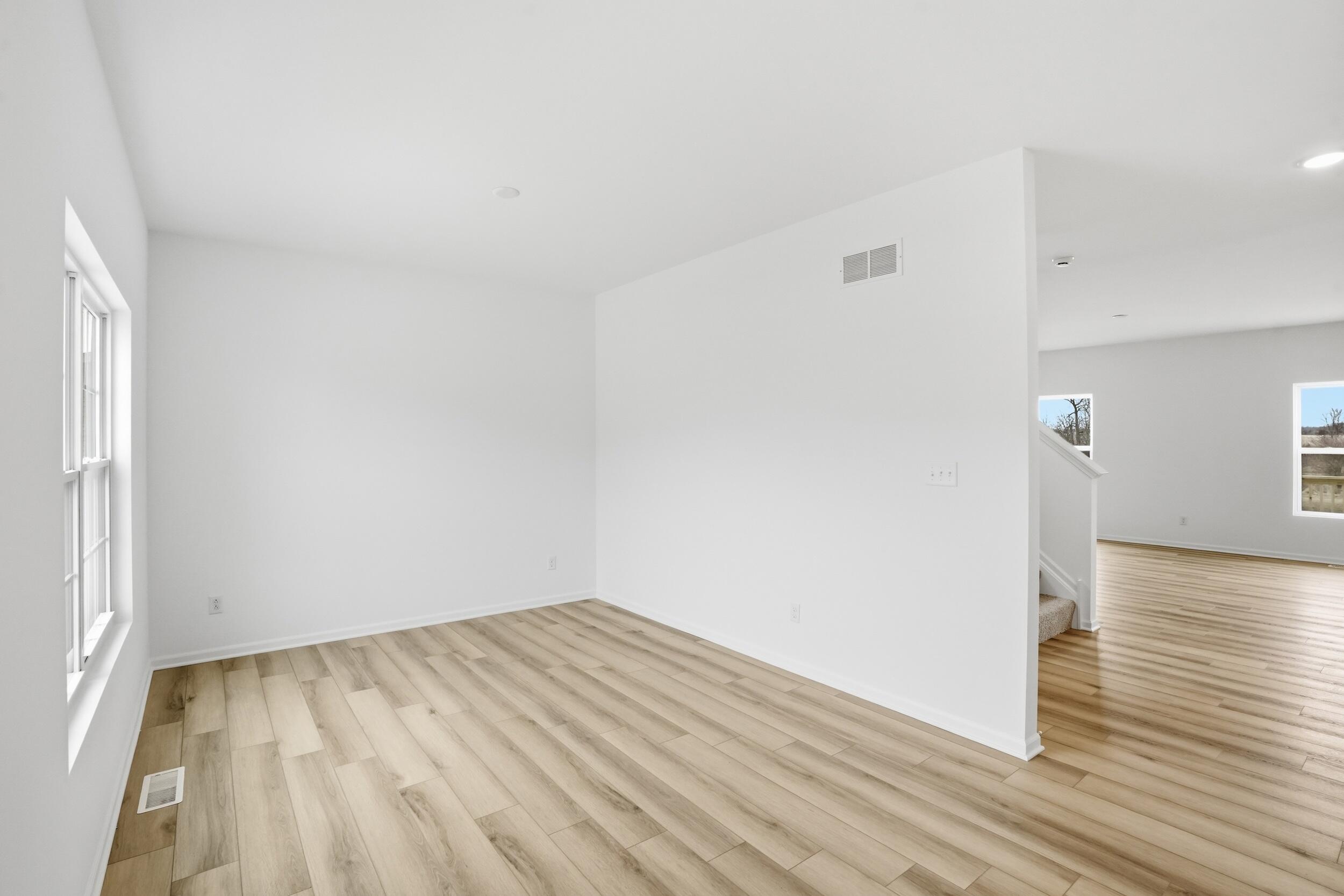 6587 East 104th Avenue Winfield, IN 46307 - Photo 4 of 34 a view of a room with wooden floor