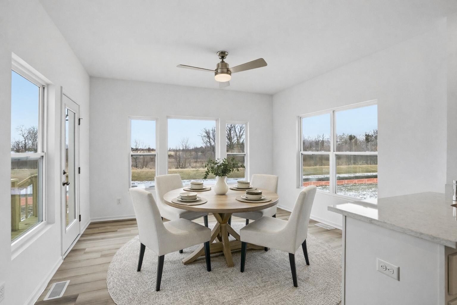 6587 East 104th Avenue Winfield, IN 46307 - Photo 7 of 34 a dining room with furniture a chandelier and wooden floor