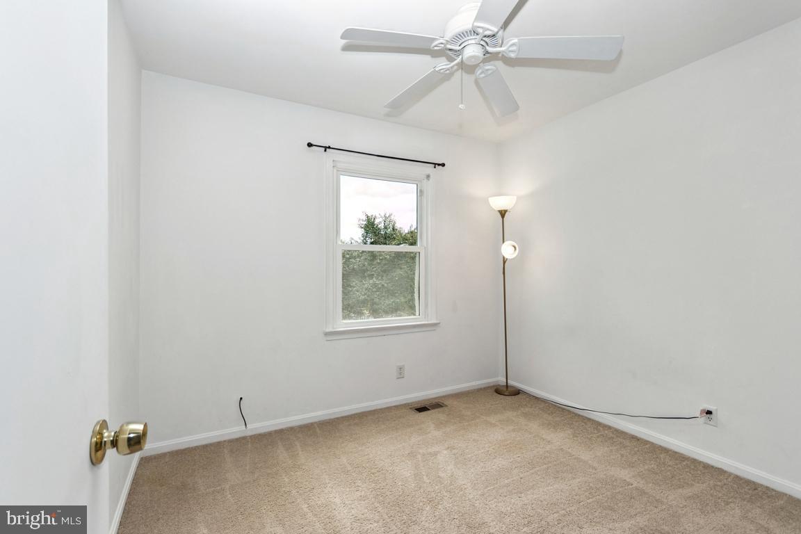 611 Madison Court, Unit 611 Stafford, VA 22556 - Photo 11 of 13 an empty room with a window and a fan