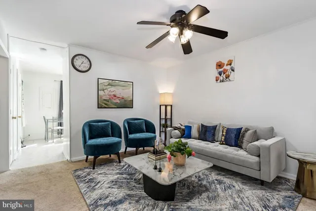 a living room with furniture a rug and a chandelier