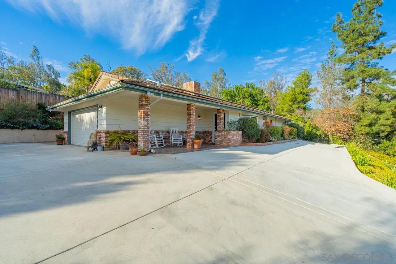 11116 Morning Dove Road Lakeside, CA 92040 - Photo 55 of 60 a view of a white house with a large tree and plants