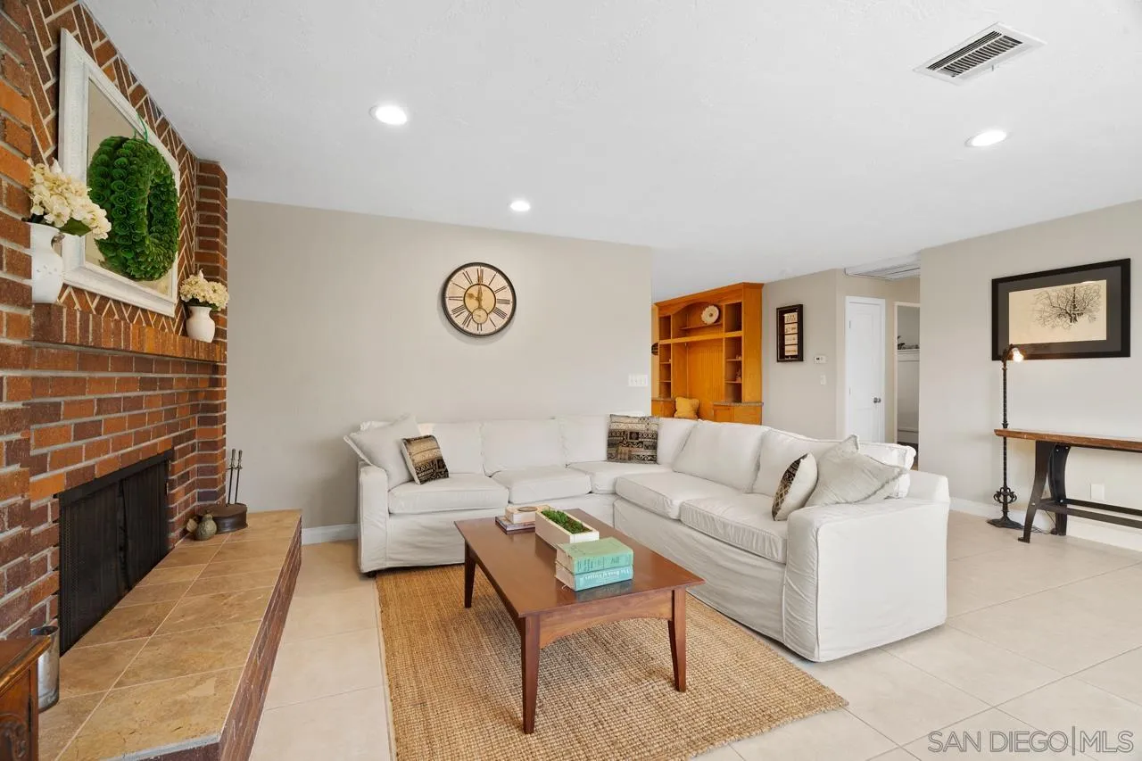 11116 Morning Dove Road Lakeside, CA 92040 - Photo 6 of 60 a living room with furniture a flat screen tv and a fireplace