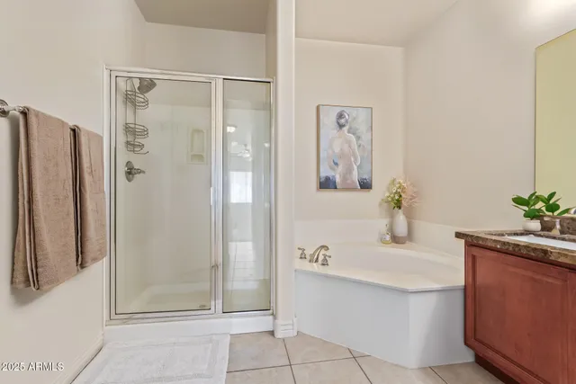 a bathroom with a tub sink and mirror