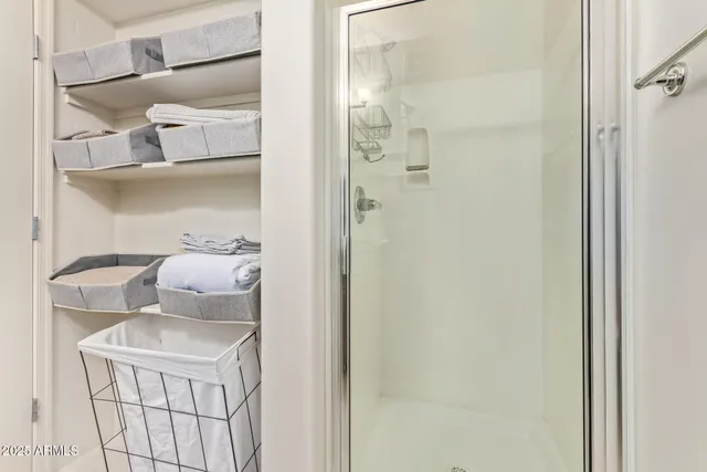 a bathroom with a sink and mirror with shower
