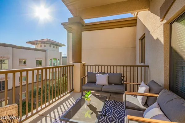 a view of a balcony with furniture