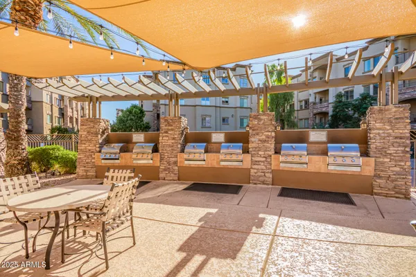 a view of a patio with dining table and chairs