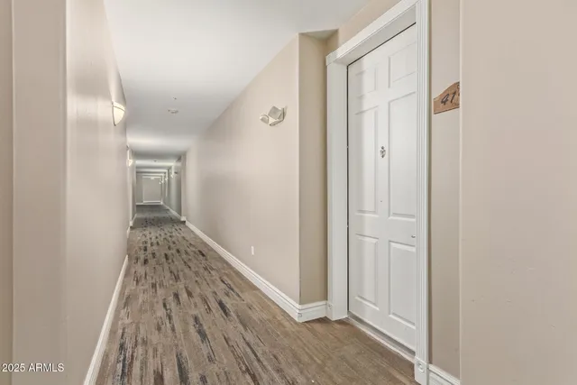 a view of hallway with wooden floor