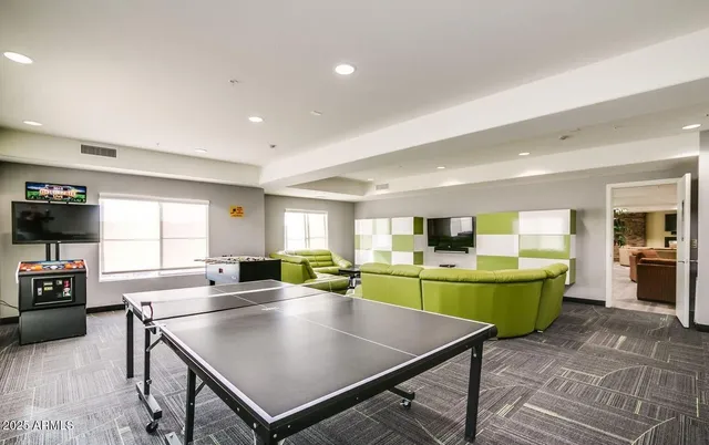 a view of a dining room with furniture and a window
