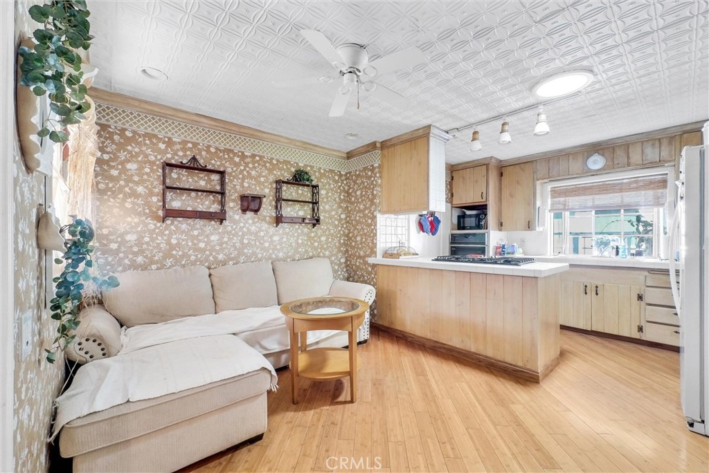 440 Cabrillo Street Costa Mesa, CA 92627 - Photo 13 of 36 a kitchen with stainless steel appliances kitchen island granite countertop a stove and white cabinets