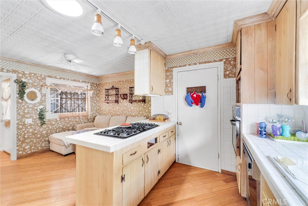 440 Cabrillo Street Costa Mesa, CA 92627 - Photo 16 of 36 a kitchen with stainless steel appliances granite countertop a stove a sink dishwasher and cabinets with wooden floor