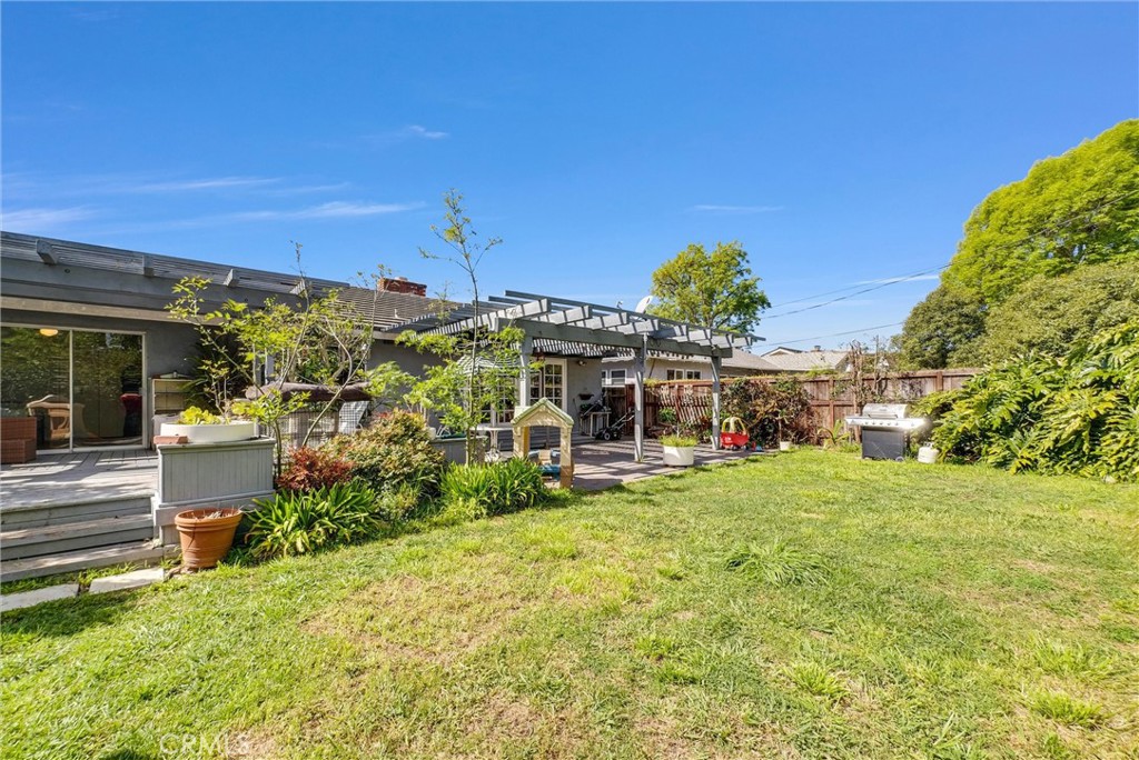 440 Cabrillo Street Costa Mesa, CA 92627 - Photo 29 of 36 a view of a house with a big yard potted plants and large tree