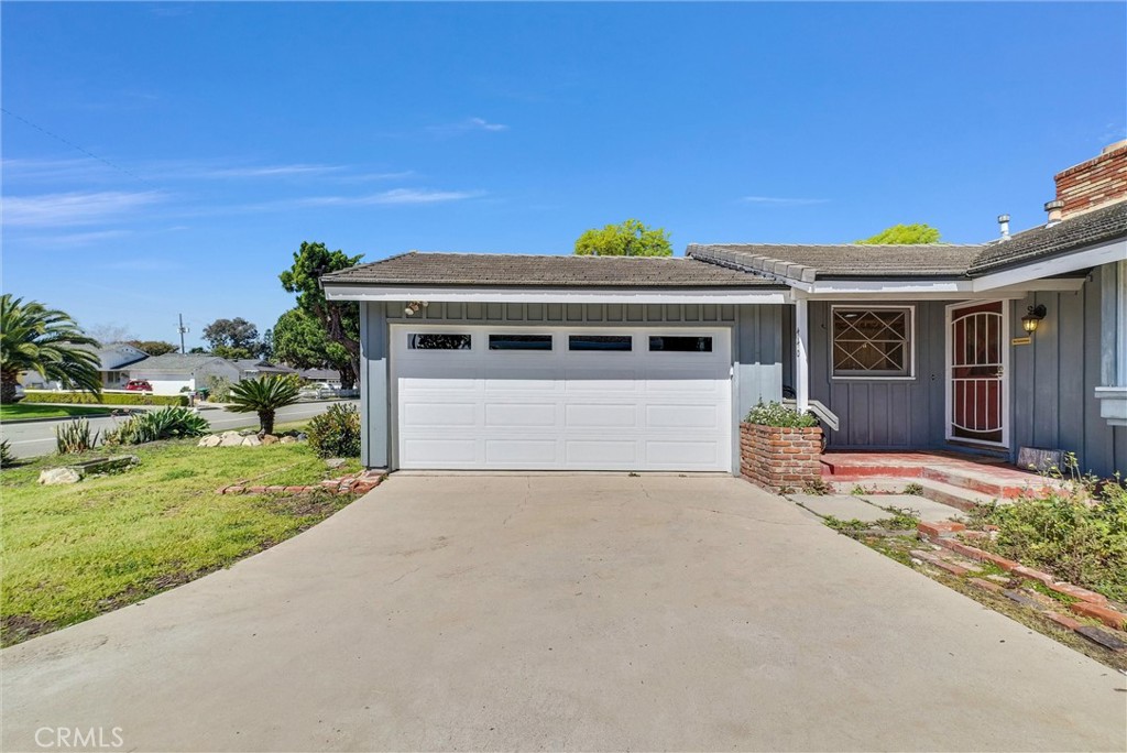 440 Cabrillo Street Costa Mesa, CA 92627 - Photo 3 of 36 a front view of a house with a yard and garage