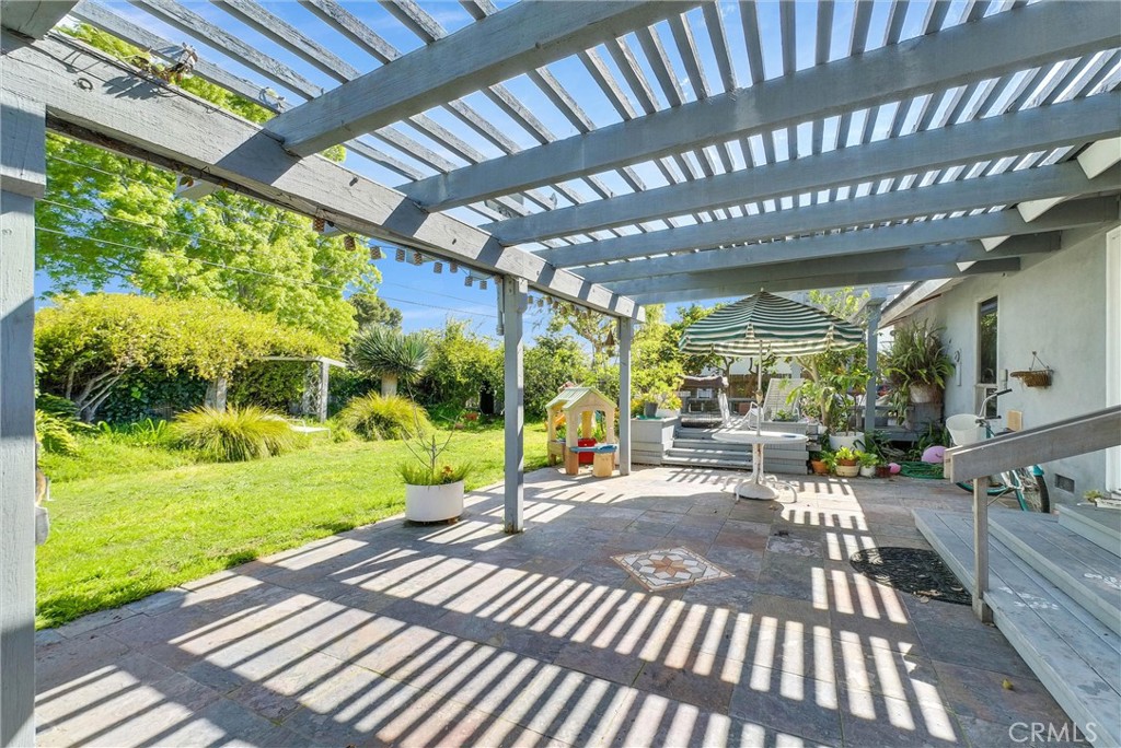 440 Cabrillo Street Costa Mesa, CA 92627 - Photo 31 of 36 a view of a patio with table and chairs and potted plants with wooden floor