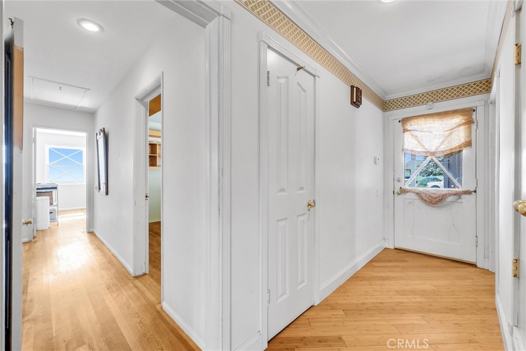 440 Cabrillo Street Costa Mesa, CA 92627 - Photo 6 of 36 a view of a hallway with wooden floor and a bathroom