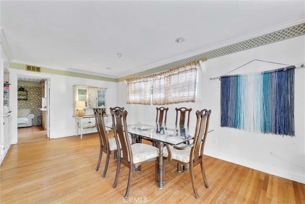 440 Cabrillo Street Costa Mesa, CA 92627 - Photo 9 of 36 a view of a dining room with furniture and wooden floor