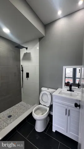 a bathroom with a toilet and a shower