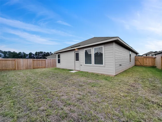 a view of a house with a backyard