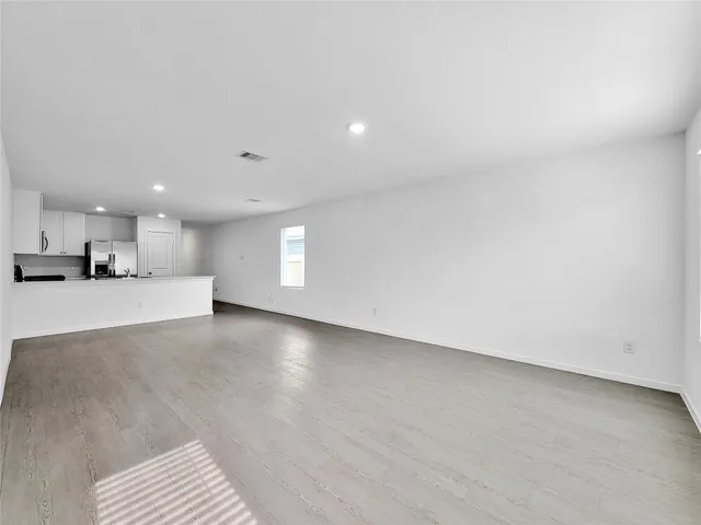 a view of a kitchen with a sink and a window