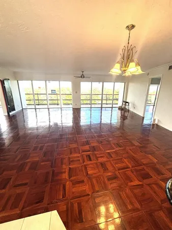 a room with pool table and windows