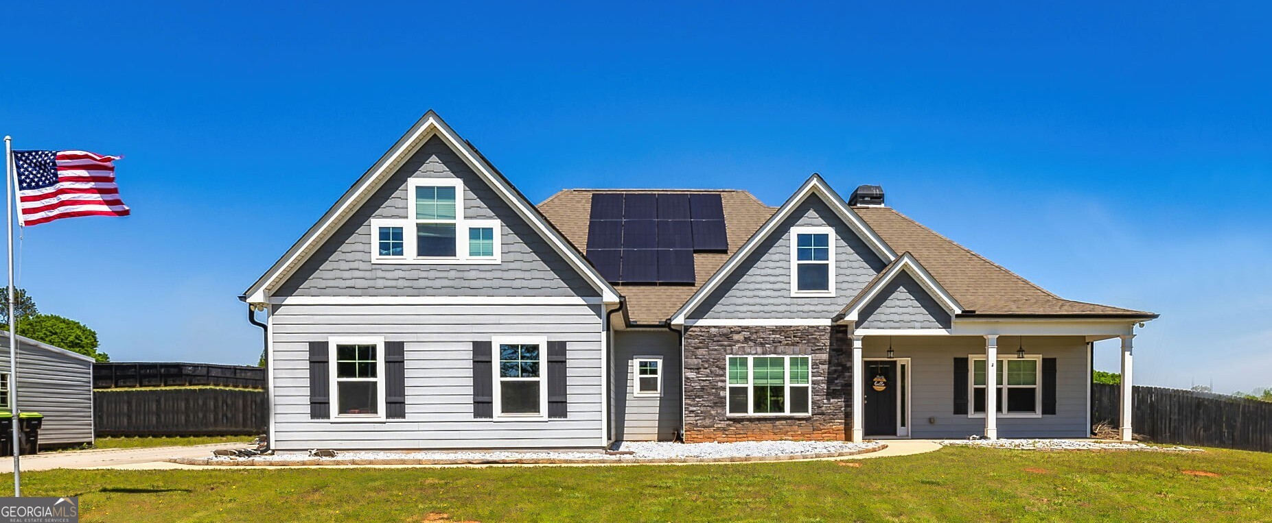a view of a house with swimming pool and wooden fence