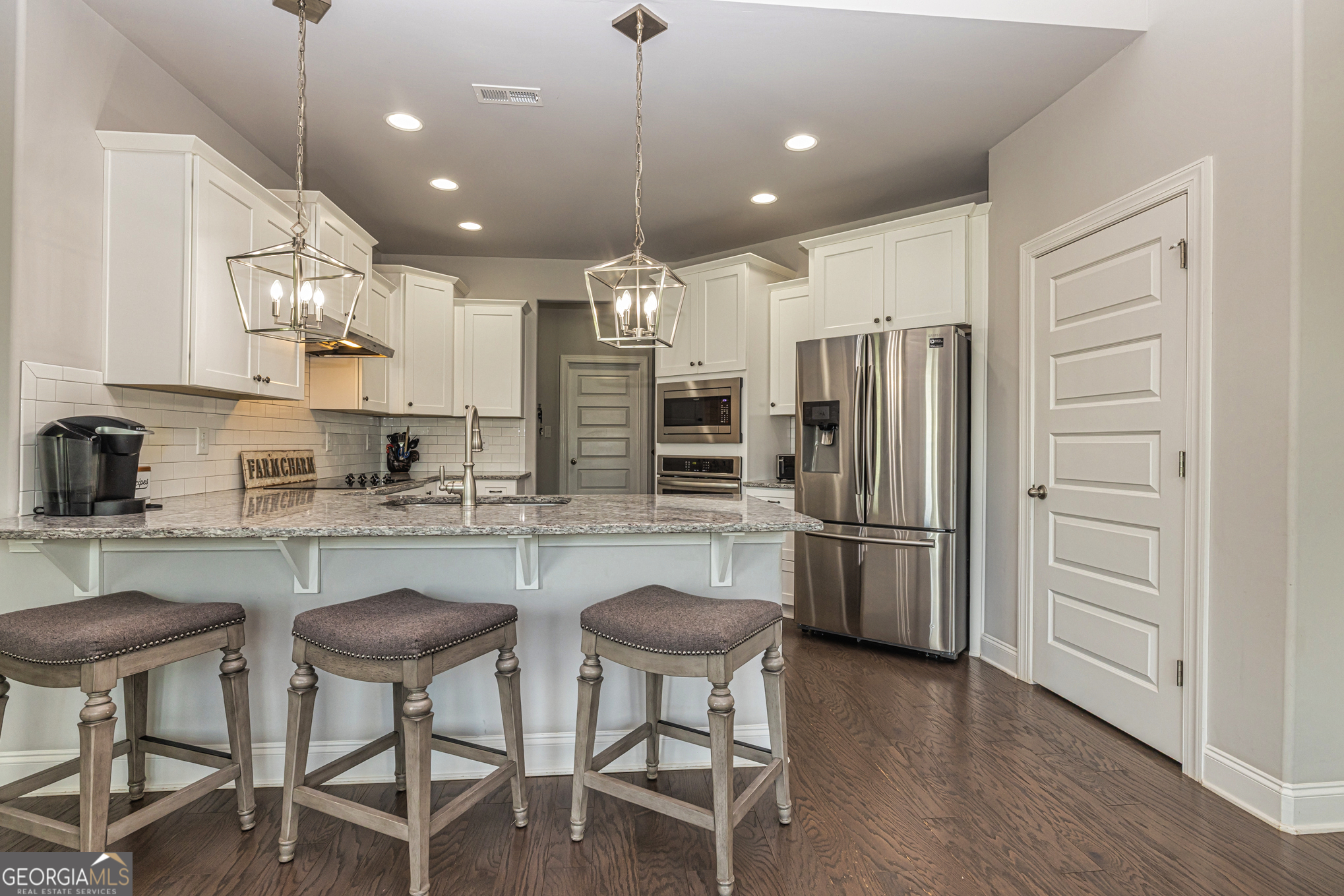941 Highway 16 Newnan, GA 30263 - Photo 12 of 43 a kitchen with refrigerator and chairs